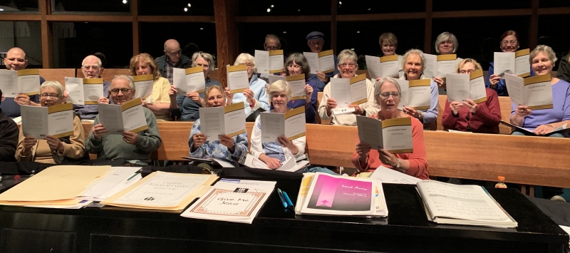 Photograph of the choir of the United Church of Rowayton receiving the published scores of this work