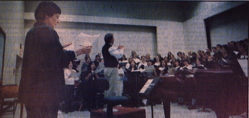 A photo of Gwyneth Walker listening to Robert Bode and the Whitman College Chorale